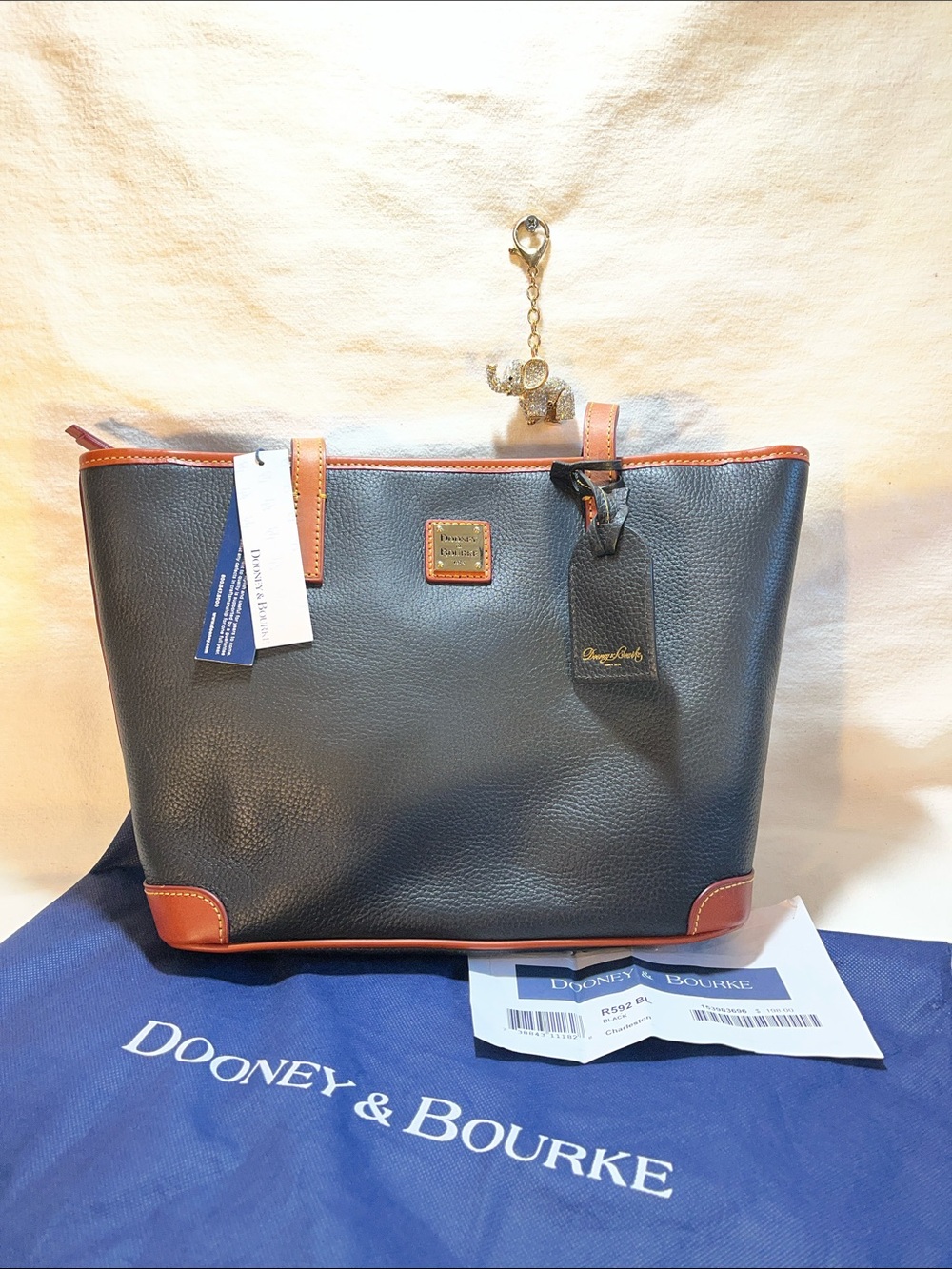 Dooney & Bourke Charleston w/ dust bag. Pebbled Black and tan leather. (P-33)